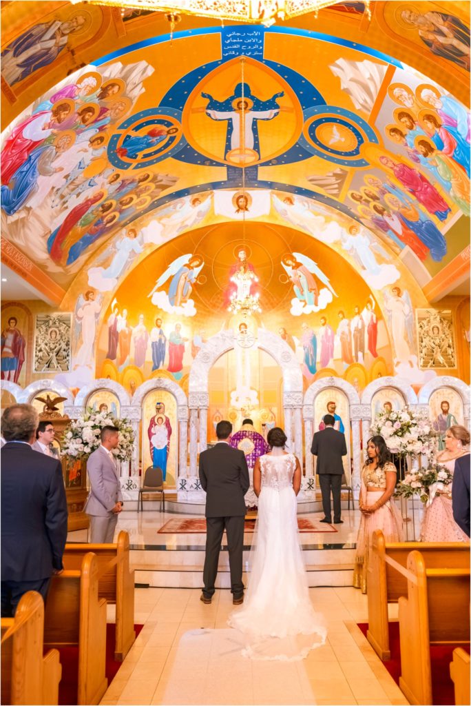 Wide photo of a colorful Marthoma church during a wedding ceremony